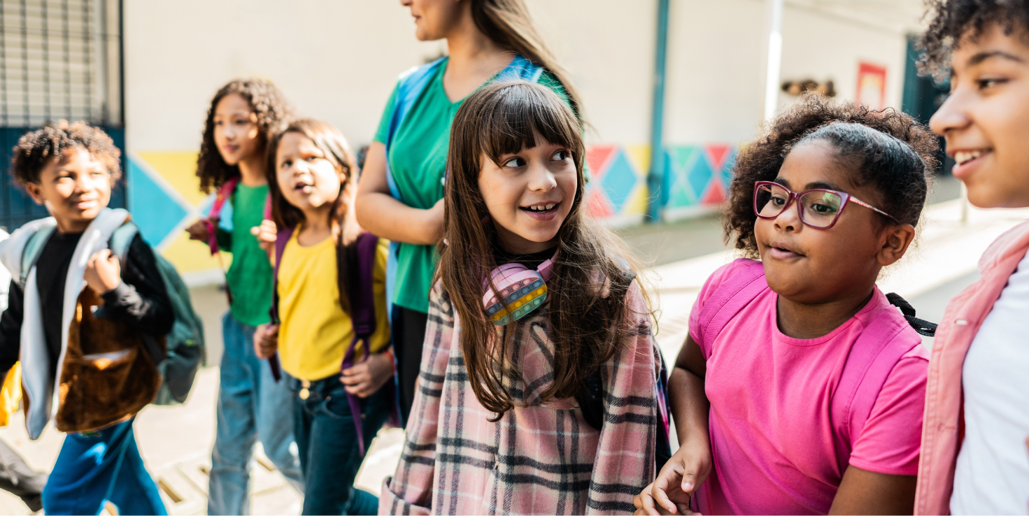 Elementary aged students walking to class