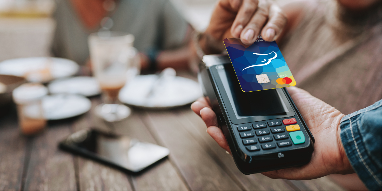 Someone paying with their Cinfed debit card at a mobile point of sale system
