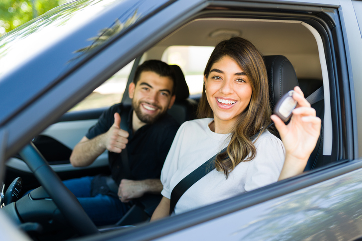 Couple Showing Off New Car With Keys In Hand