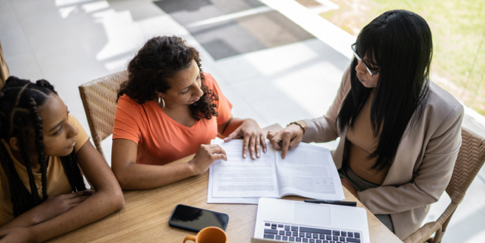 Woman helping other woman with her furlough loan opportunity