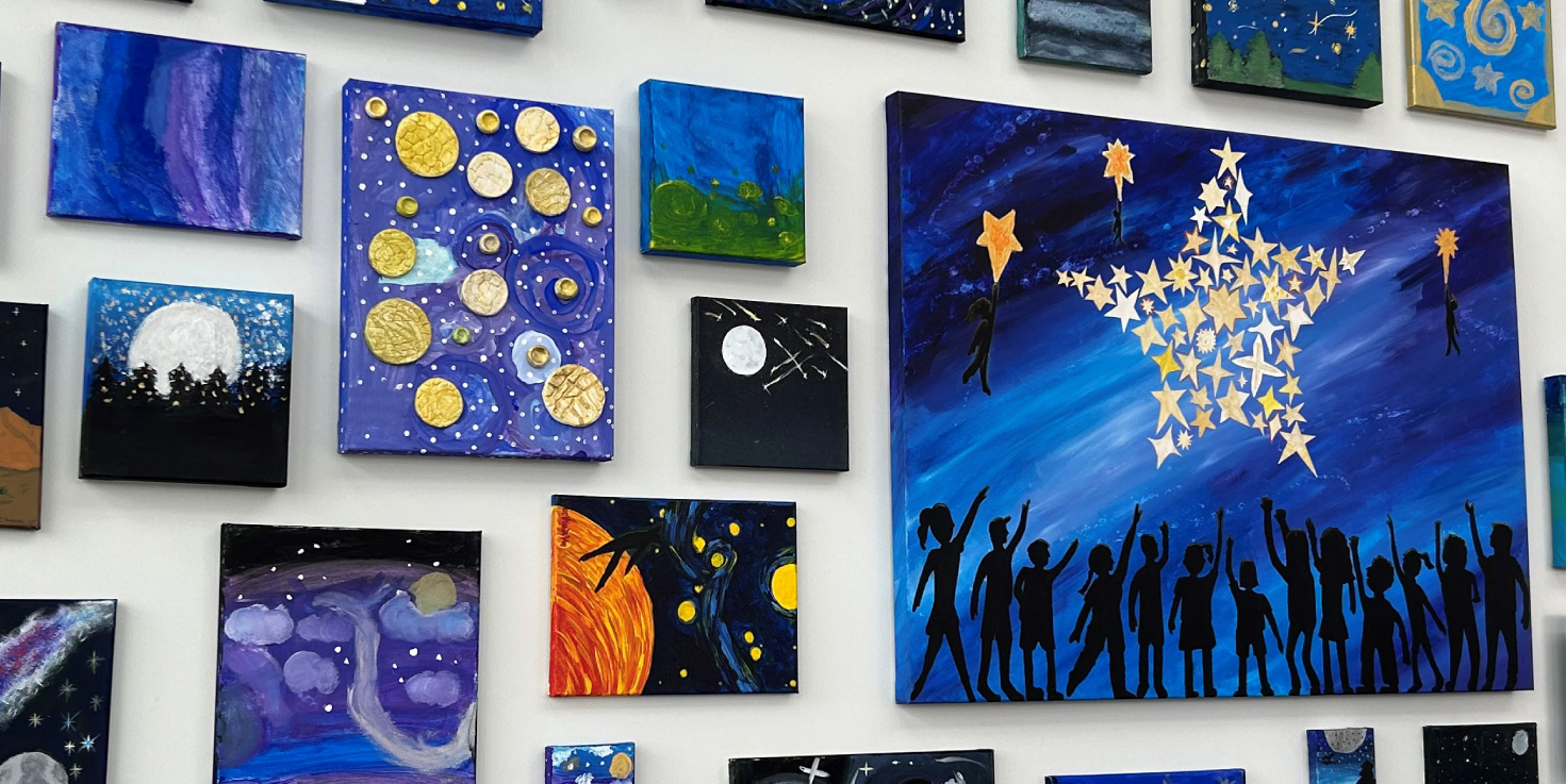 Photo of gallery wall at Cinfed's Colerain branch. Featuring art of local primary schools.