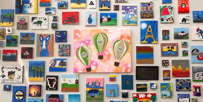 Photo of gallery wall at Cinfed's Colerain branch. Featuring art of local primary schools.